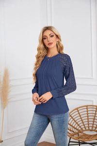 Detail of navy blue long sleeve top featuring lace patchwork cuffs and pleated neckline