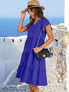 Detail of royal blue tiered dress featuring a V-neckline and ruffled butterfly sleeves