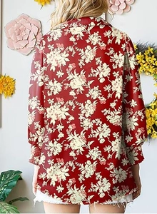 Detail of floral print blouse with lantern sleeves and elegant shirt collar design