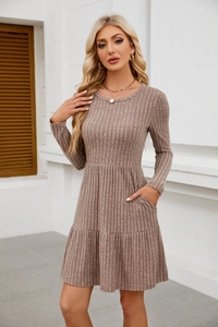 Detail of ribbed knit fabric on casual long sleeve dress with tiered hem and pockets