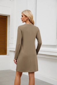 Back view of a khaki long sleeve mini dress featuring a stylish hem slit and knitted fabric