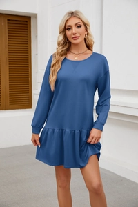 Detail view of the elegant ruffle hem and long sleeves on a navy blue casual dress