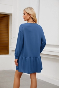 Detail view of long-sleeve casual dress in navy blue with stylish ruffled hem detail