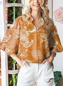 Detail of long lantern sleeves and mustard paisley patterns on a chic collared blouse