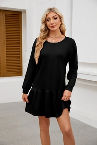 Detail of a casual black long-sleeved dress featuring a crew neck and ruffled hemline