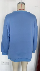 Back view of light blue oversized sweatshirt with drop shoulder and ribbed hem on mannequin