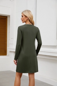 Detail view of the back seam and slim fit of this olive green long sleeve mini dress
