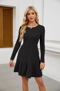 Detailed macro view of black ribbed knit long sleeve mini dress with ruffle hem detail