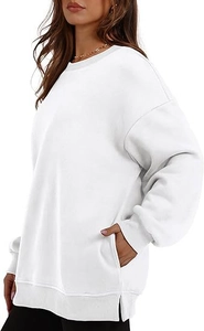 Detail view of white oversized sweatshirt showing side slit and hidden side pocket