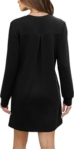 Detail view of the vertical pleat design on the back of a black long sleeve mini dress