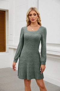 Macro detail of dark green ribbed knit fabric texture and square neck design on mini dress