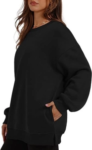 Detail view of oversized black sweatshirt featuring practical side pockets and ribbed cuffs