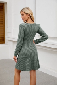 Detail of sage green ribbed knit dress featuring a square neck and lantern sleeve design