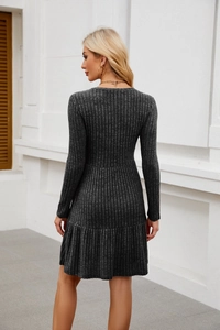 Detail of charcoal grey ribbed knit dress with slim fit and elegant ruffle hemline