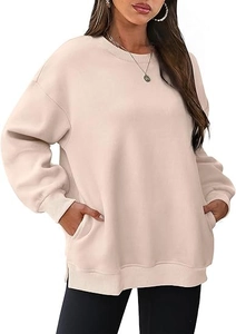 Detail of oversized cream sweatshirt featuring side slits and hidden side pockets