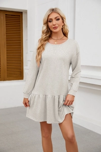 Detail of grey long sleeve dress with a stylish flounce hem and textured knit fabric