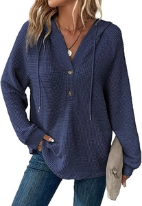 Detailed view of the V-neck with wooden buttons and drawstrings on the blue waffle hoodie