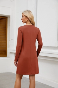 Detail of rust red knit long sleeve mini dress showing the back fit and fabric texture