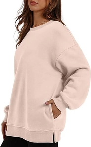 Side view of oversized crewneck sweatshirt featuring ribbed cuffs and side slit detail
