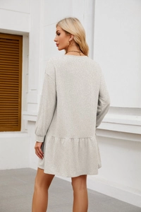 Detail of grey long sleeve babydoll dress with ruffle hem and casual round neck