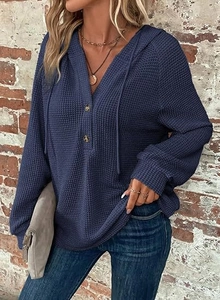 Close-up detail of dark blue waffle knit texture on women's V-neck drawstring hoodie