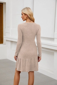 Detail view of beige ribbed knit texture and ruffled hem on casual long sleeve dress