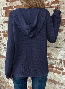 Back view of a navy blue waffle knit hoodie showing the texture and relaxed casual fit