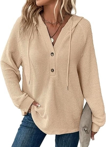 Detailed waffle knit fabric texture on a beige V-neck drawstring hoodie for women