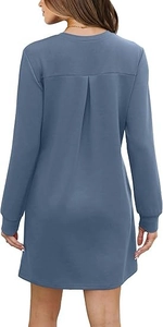 Detail of grey-blue long sleeve dress featuring back pleated design and ribbed cuffs