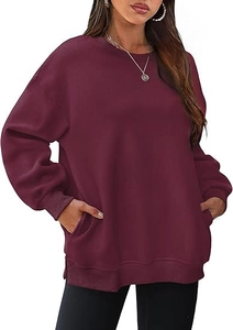 Detailed view of dark red oversized sweatshirt with ribbed cuffs and side slit design
