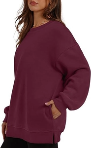 Detail view of burgundy oversized sweatshirt with side slits and hidden side pockets
