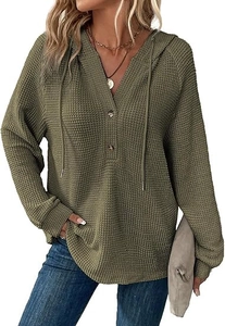 Detail of waffle knit fabric texture and buttoned V-neckline on olive green hoodie