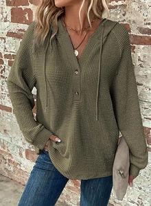 Detailed waffle knit texture on olive green hoodie with two-button henley collar