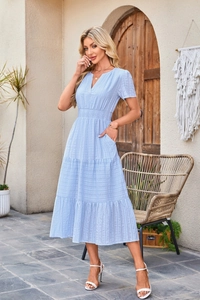 Macro view of light blue dress showing V-neckline and textured striped fabric detail