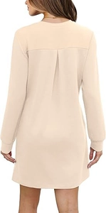 Detail view of beige long-sleeve sweatshirt dress featuring back pleats and ribbed cuffs