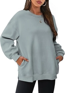 Detailed view of oversized crewneck sweatshirt featuring functional side pockets and ribbing