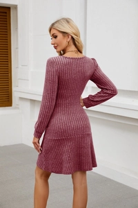Close-up of dark rose pink knit dress fabric showing vertical ribbing and high waist detail