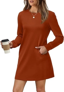 Detail of crewneck orange knit dress with functional side pockets and ribbed cuffs