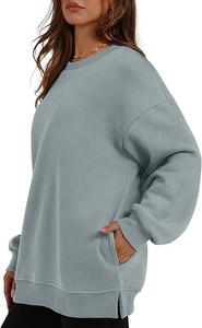 Detail of oversized drop shoulder sweatshirt with side slits and rib knit cuffs