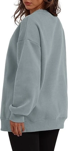 Rear side view of oversized crewneck sweatshirt in grey with ribbed cuffs and loose fit