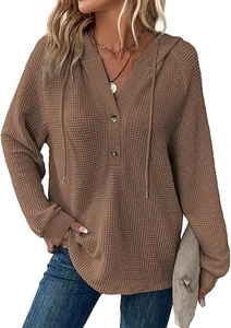 Detail of waffle knit fabric on V-neck brown drawstring hoodie with button neckline