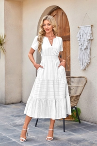 Detail view of white V-neck mini dress showing striped texture and tiered ruffle skirt