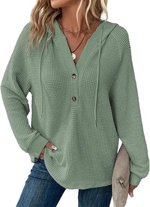 Detailed close-up of waffle knit texture and V-neck button design on light green hoodie