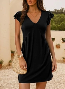 Detail of a V-neck black mini dress with ruffle sleeves in a resort style look
