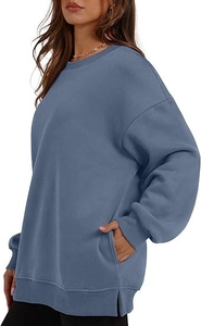 Detail view of oversized crewneck sweatshirt with side slits and side pockets in dusty blue
