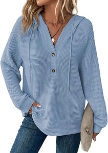 Detail of light blue waffle knit hoodie featuring V-neck buttons and drawstring texture
