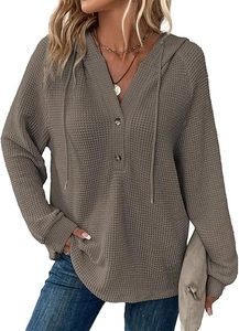 Detail view of waffle knit fabric on long sleeve V-neck drawstring hoodie sweater