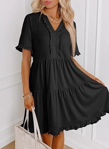 Detail of V-neck ruffled sleeves and tiered cake skirt design on a black summer mini dress