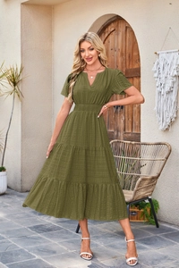 Detail of olive green V-neck midi dress with tiered skirt and textured fabric