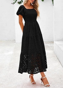 Full view of elegant black square neck tiered dress with puff sleeves and embroidery